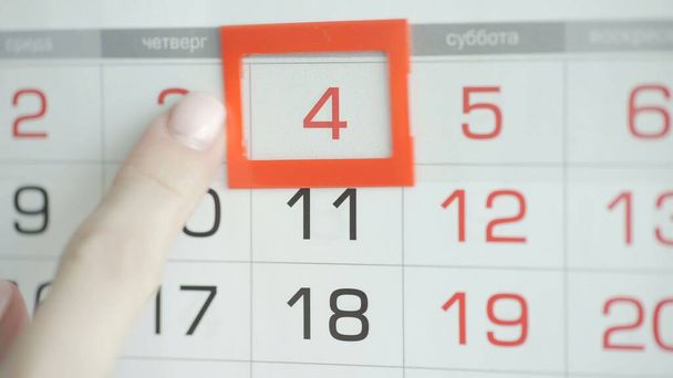 Womans hand in office changes date at wall calendar. 4 - Photo, Image