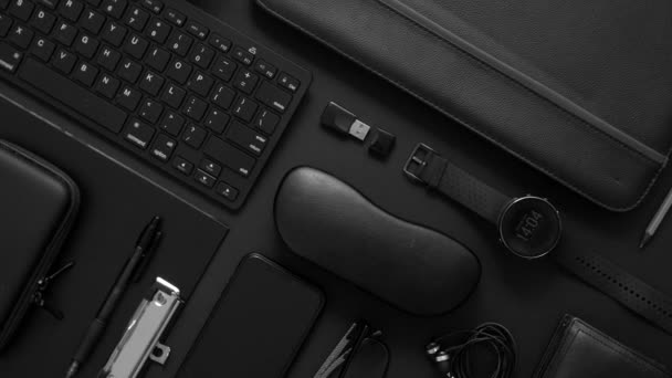 Business concept. Flat lay composition with various black gadgets on dark black surface - Footage, Video