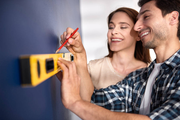 Couple preparing wall for new decorations - Photo, Image