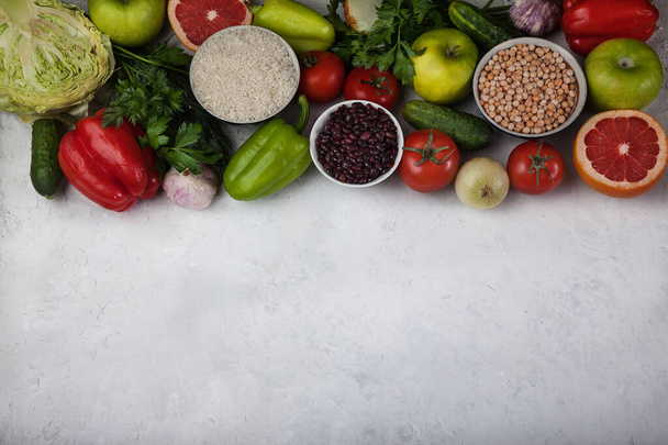 The concept of a healthy vegetarian food, rice products, chickpeas, vegetables and fruits on a light background. Food rich in antioxidants and vitamins. Copy spaes - Fotó, kép