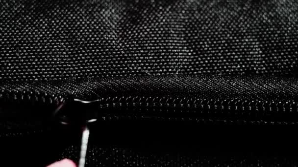 Buttoning a black zippers closeup. Black fabric material texture macro zipper. - Footage, Video