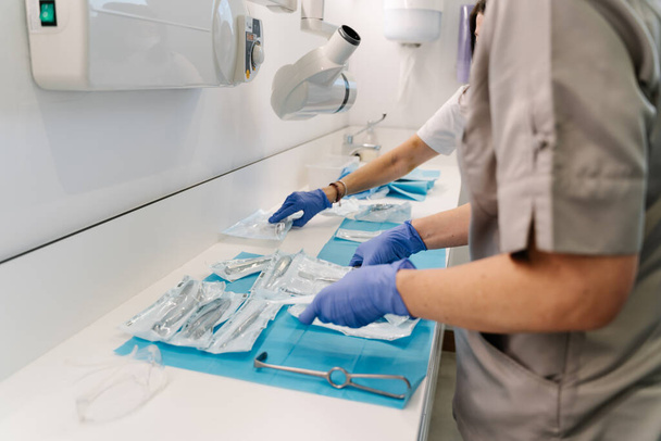 Ramasser des instruments médicaux pour les dentistes après une opération - Photo, image