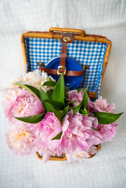 A beleza de um buquê de peônias rosa em uma mala marrom autêntica vintage, close-up. Bela composição
. - Foto, Imagem