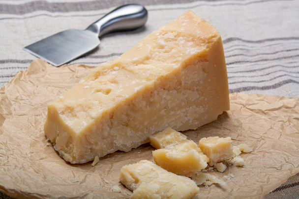 Cheese collection, Piece of Italian original aged Parmesan cheese and cheese knife close up - Photo, Image