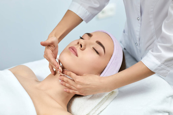 young beautiful woman receiving the facial massage - Foto, Imagem