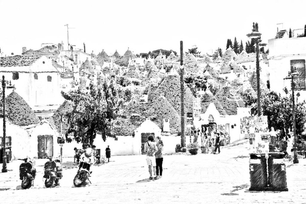 Dibujo en blanco y negro computarizado que representa la plaza principal de Alberobello en Puglia y en el fondo los trulli, las casas típicas del lugar
. - Foto, imagen