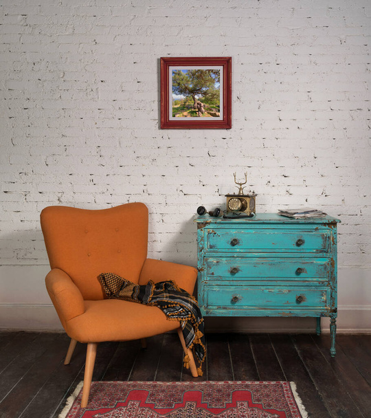 Vintage turquoise cabinet with orange stylish armchair in room interior - Photo, Image