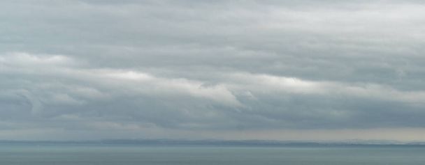 Abstract panaroma landscape view of Lake Constance with stormy clouds and rainy weather atmosphere - Photo, Image