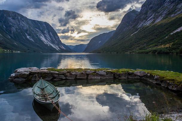 sunset and heavy clouds over the fjord in Norway - Фото, изображение