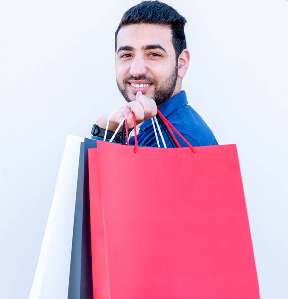 Arabic guy holding shopping bags in his hand - Photo, Image
