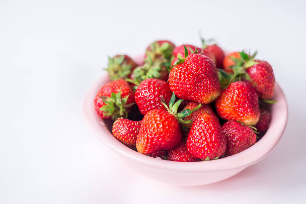 strawberries in a bowl on a white background. - Foto, Bild