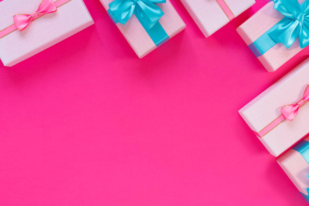 Set of beautiful gift boxes with blue bows on pink background. Holiday sale - Valokuva, kuva