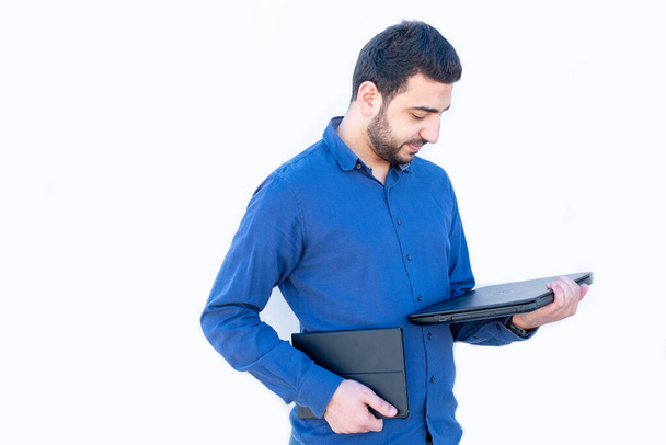 Arabic guy holding laptop in his hands - Фото, зображення