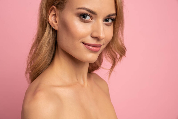 Portrait of pretty charming cute girl with plump lips looking at camera having perfect skin isolated on pink background, advertisement concept. copy space. - Foto, immagini