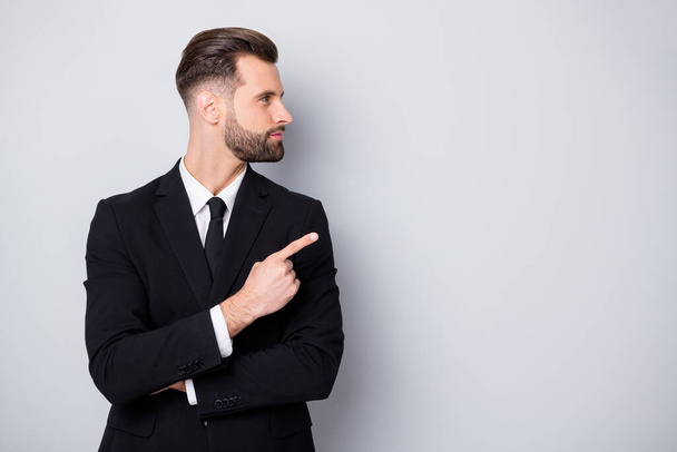 Profile side photo of smart confident man company owner point index finger copyspace direct way ads promotion wear black formalwear clothing isolated over grey color background - 写真・画像