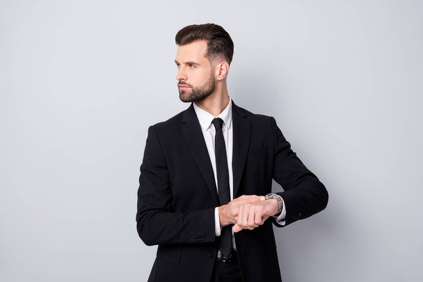 Profile side photo of stylish cool executive worker man appoint meeting with partner late check time oh his wrist watch look copyspace wear classy outfit isolated over grey color background - Valokuva, kuva