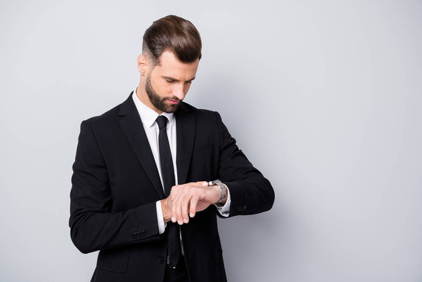 Portrait of serious concentrated man appoint meeting with his clients wait check time on wrist watch wear formalwear outfit isolated over grey color background - Fotografie, Obrázek