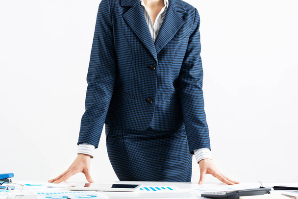 Businesswoman in suit standing near office desk - Foto, immagini