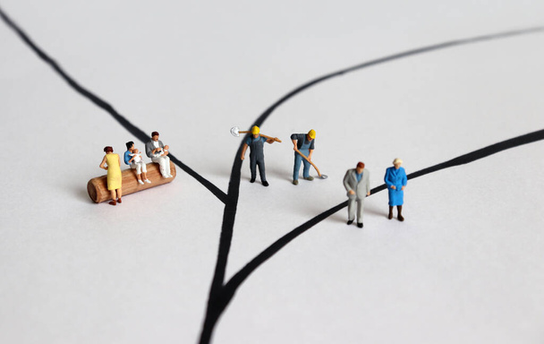 Diverse miniature people. A concept of role conflict. - Photo, Image