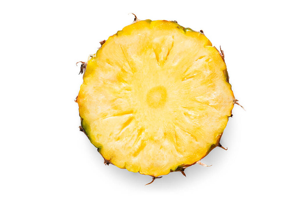 Organic ripe pineapple in a piece of cross section cut or round shape with peel on white isolated background with clipping path. Pineapple is summer tropical fruit which have sweet and sour taste. - Photo, Image