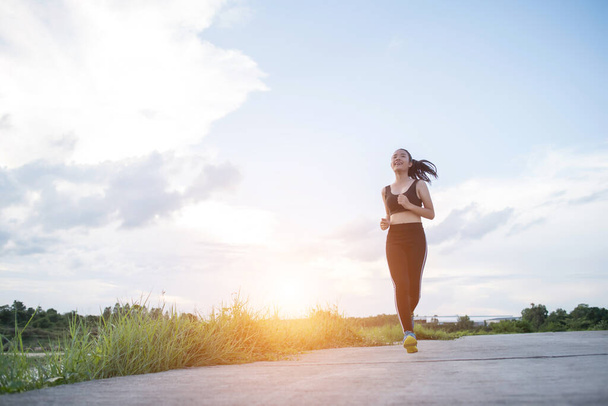 Happy runner woman runs in the park jogging exercise. - Φωτογραφία, εικόνα