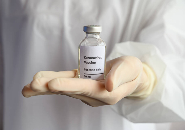 Primer plano de la mano del médico científico sosteniendo una muestra de frasco de prueba de la vacuna Covid-19. La vacunación es una de las formas más efectivas de prevenir enfermedades y ayuda al sistema inmunitario del cuerpo contra el virus.
. - Foto, imagen