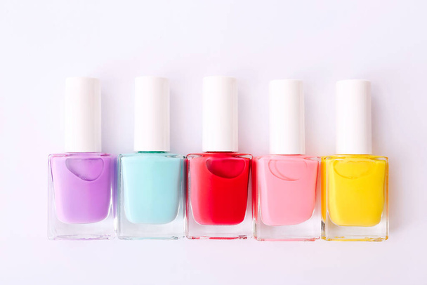Group of nail polishes of different colors on white background - Фото, зображення