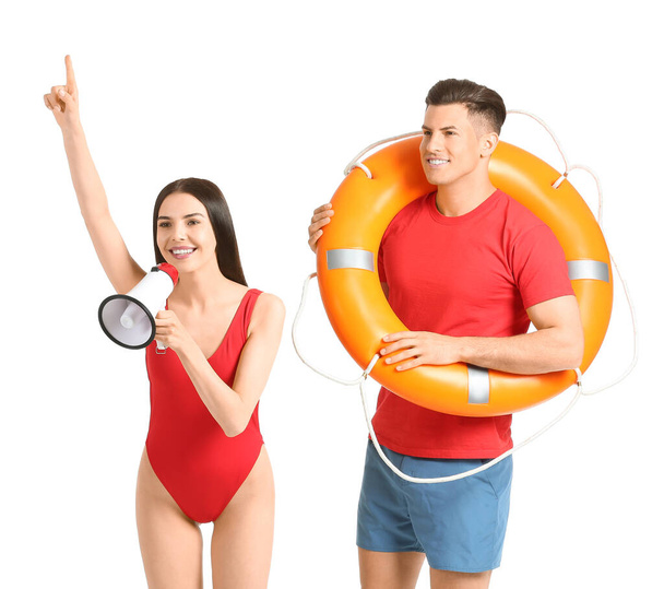 Beach rescuers with lifebuoy and megaphone on white background - Φωτογραφία, εικόνα