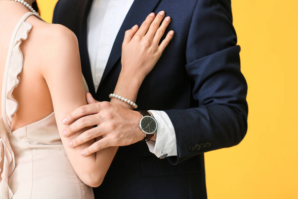 Young couple wearing stylish accessories on color background - Photo, Image