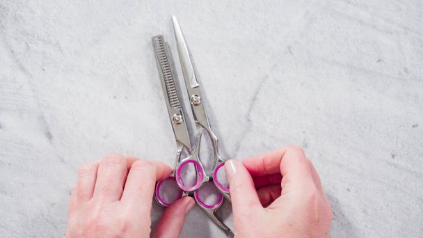 Flat lay. Pink hair cutting scissors set. - Photo, Image