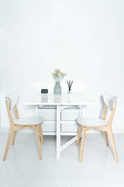 Working at home in a minimalist home. Dining tables and chairs and furnishings in a minimalist modern home.  - Foto, Imagem