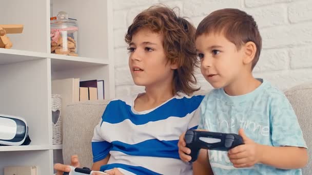 Two boys playing video game console, have fun, laugh, hold the joystick, celebrating victory, 4k - Footage, Video