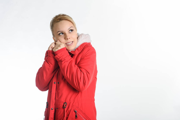 20-years blond girl in a red coat on a white background - Foto, imagen