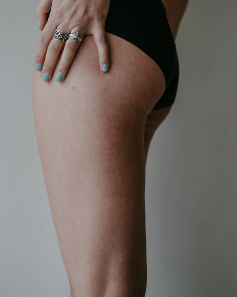 woman hips and hand in black underwear - Фото, изображение