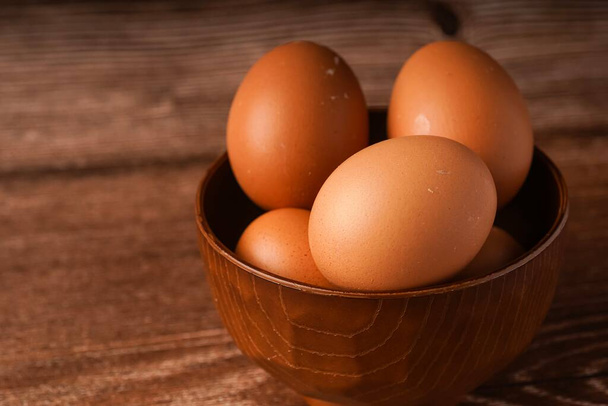 Ein Karton Eier auf einem hölzernen Hintergrund - Foto, Bild
