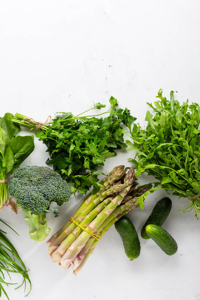 Green vegetables set on white surface - Фото, изображение