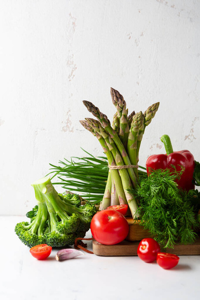 Asparagus bunch and broccoli still life, food close up - 写真・画像
