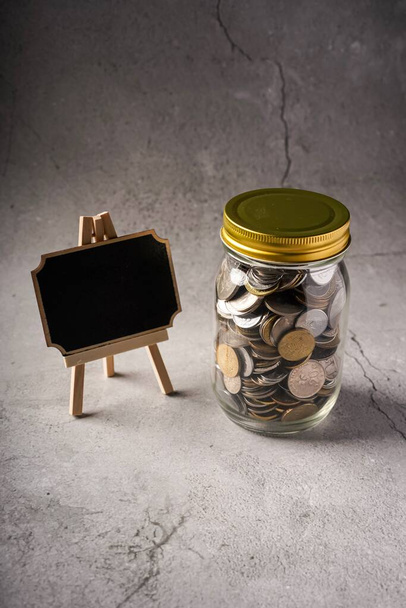 Savings concept: coins in jar with copy space for text - Fotoğraf, Görsel