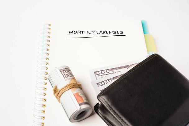 Monthly Expenses wordings on a notebook with wallets on the side - Photo, Image