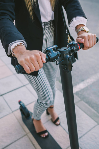 Unrecognizable businesswoman with e-scooter outdoors - Fotoğraf, Görsel