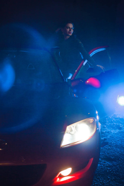Woman with car in lights at night - Fotó, kép