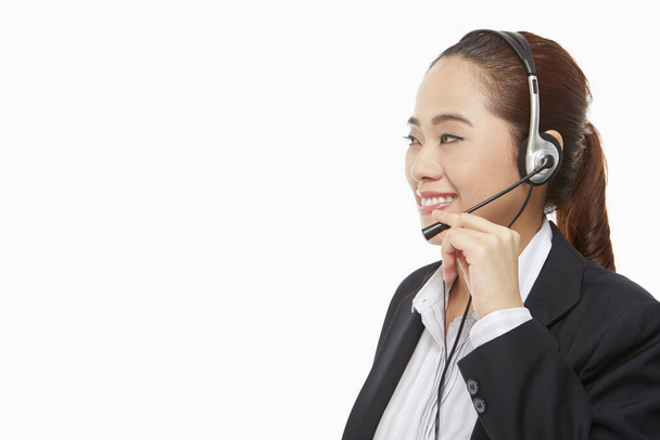 Smiling businesswoman with headset - Zdjęcie, obraz