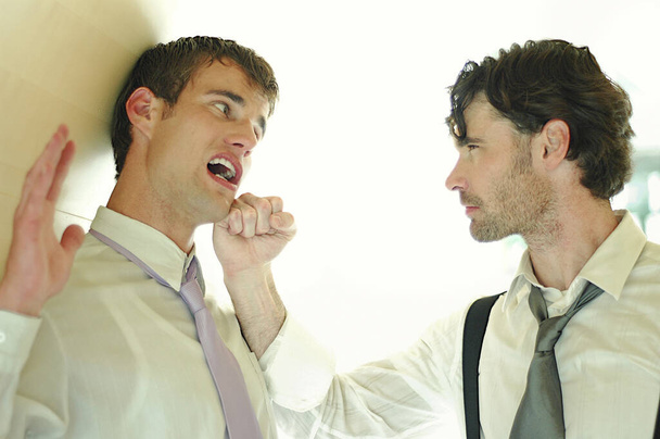 A man threatening a guy with his knuckle - Фото, зображення