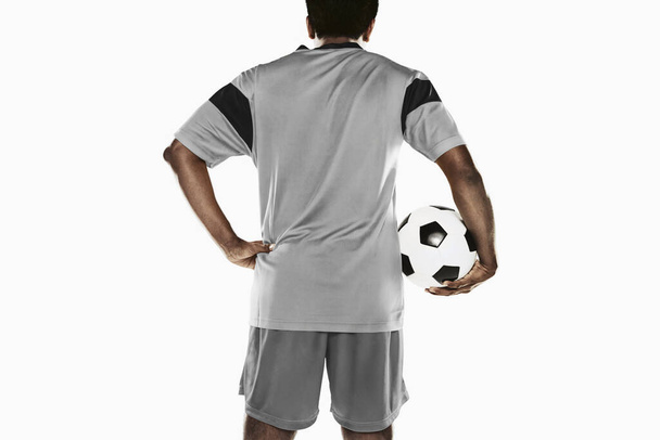 A soccer player holding a ball - Фото, зображення