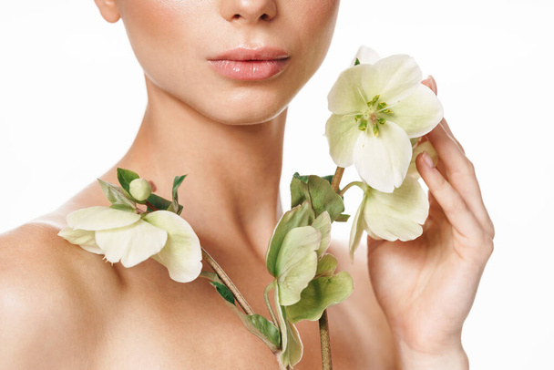 Cropped image of beautiful shirtless woman posing with flower isolated over white background - Φωτογραφία, εικόνα