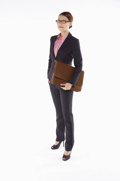 Businesswoman carrying a briefcase - Fotó, kép