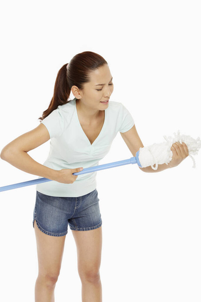 Woman squeezing the head of a mop - Photo, Image