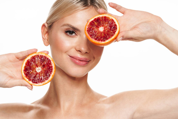 Image of beautiful smiling shirtless woman posing with red orange isolated over white background - Foto, immagini