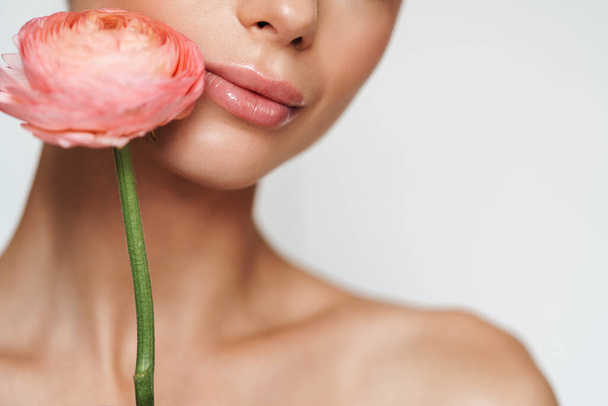 Cropped image of beautiful seductive shirtless woman posing with flower isolated over white background - Φωτογραφία, εικόνα