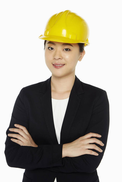 Female architect standing with arms crossed - Фото, изображение